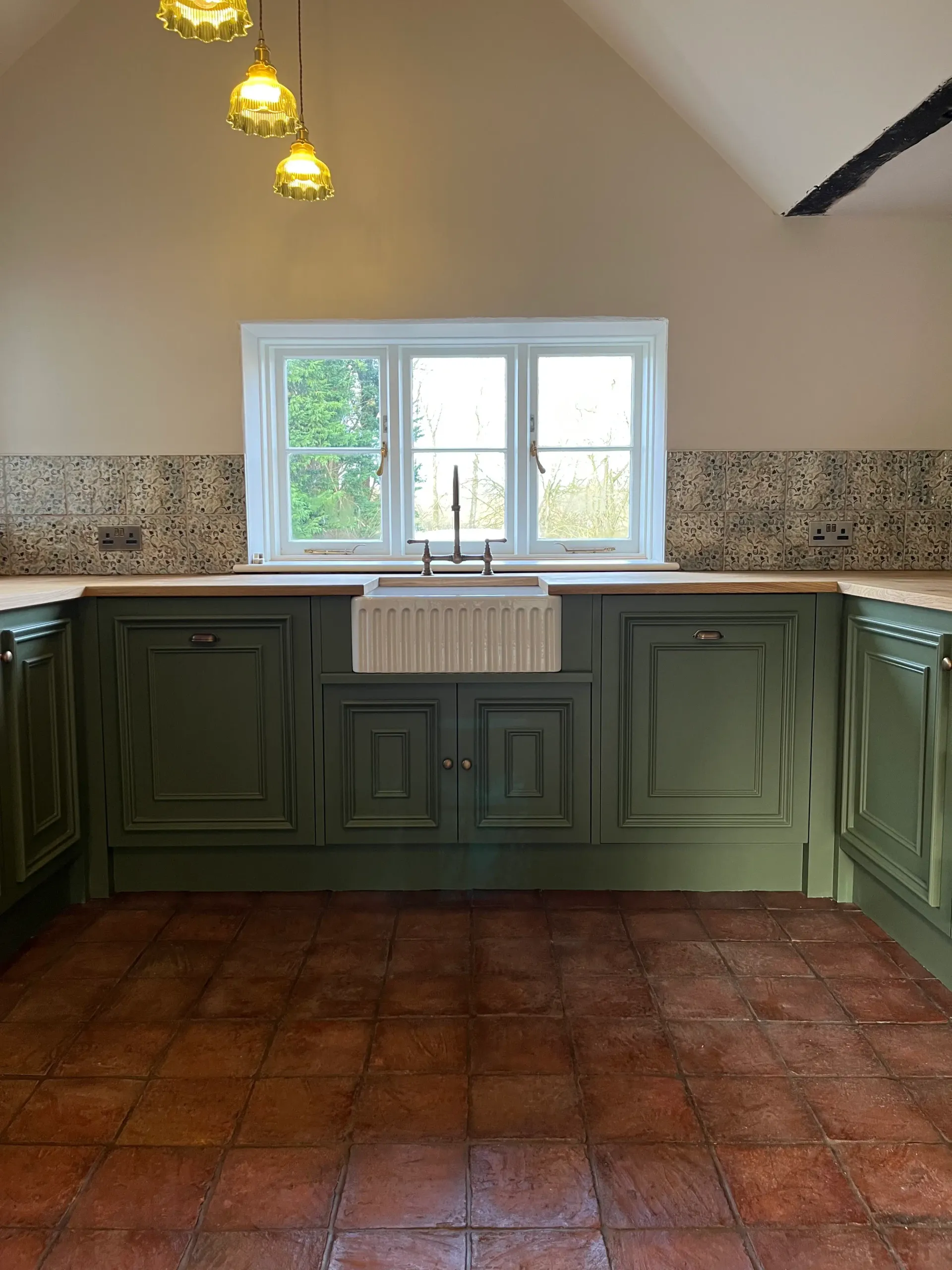 Luxury handmade kitchen — wide green cabinetry